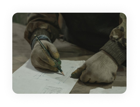 Worker drawing on plans